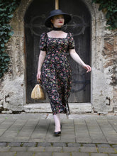 A woman wears a floral dress